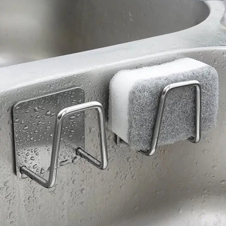 a sink with two hooks on it