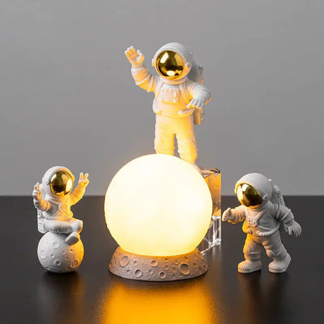 a small astronaut lamp with two small astronauts