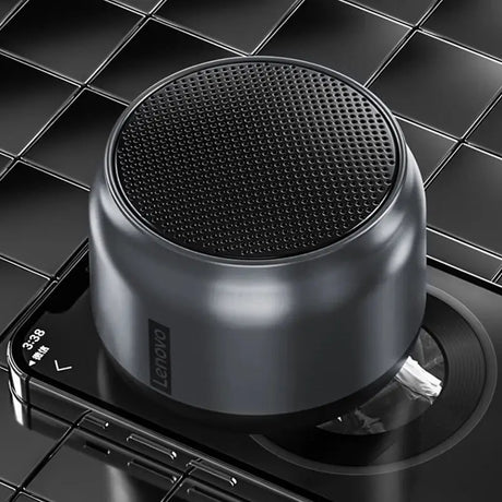 the bluetooth speaker is on top of a black surface