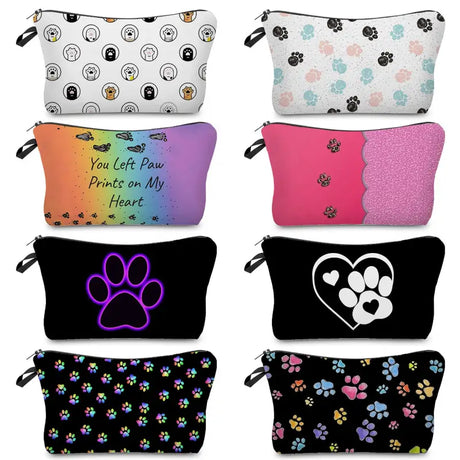 a close up of four different colored zipper bags with dog paw prints