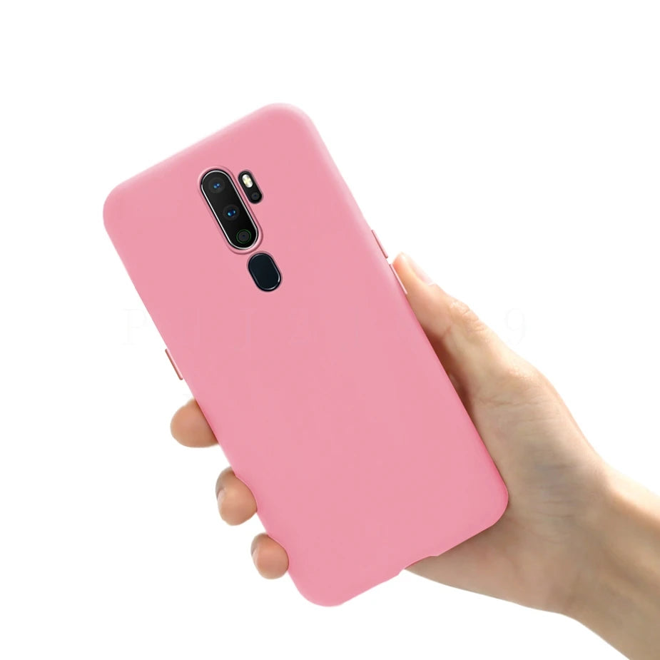 Pink silicone phone case held in a hand.