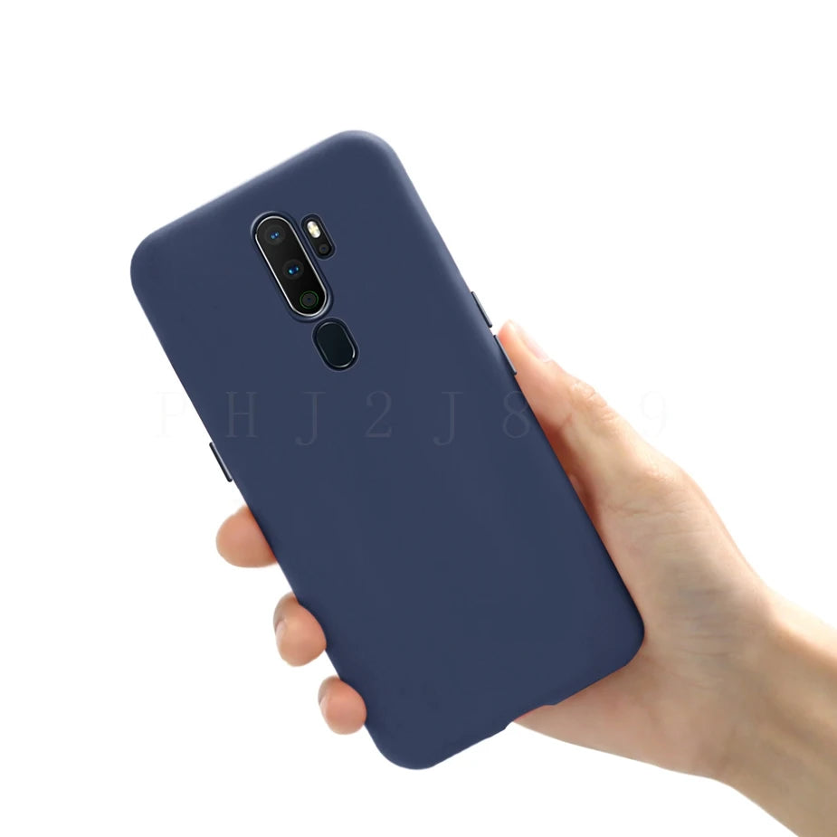 Hand holding a navy blue silicone phone case.