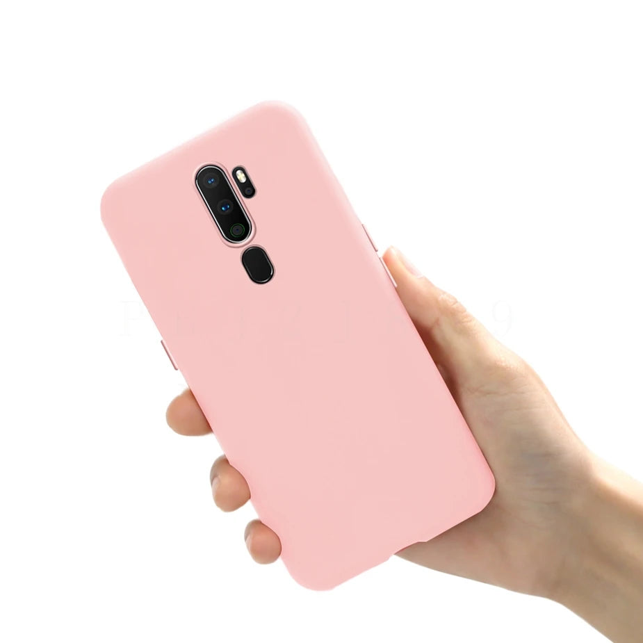 Pink silicone phone case held in a hand.