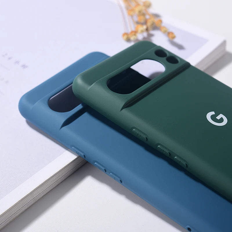 Two silicone phone cases, one blue and one green, designed for a Google Pixel phone.