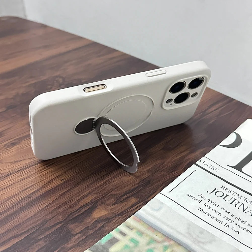 White iPhone with a magnetic ring holder and camera cutouts.