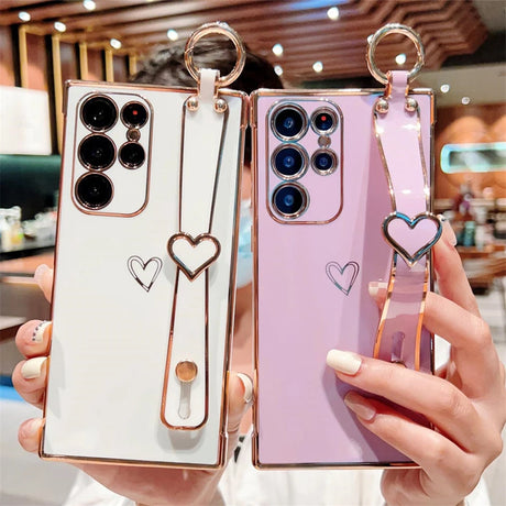Two smartphones in decorative cases with heart-shaped accents.