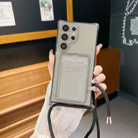 A gray smartphone in a clear case with an attached black lanyard and card holder.