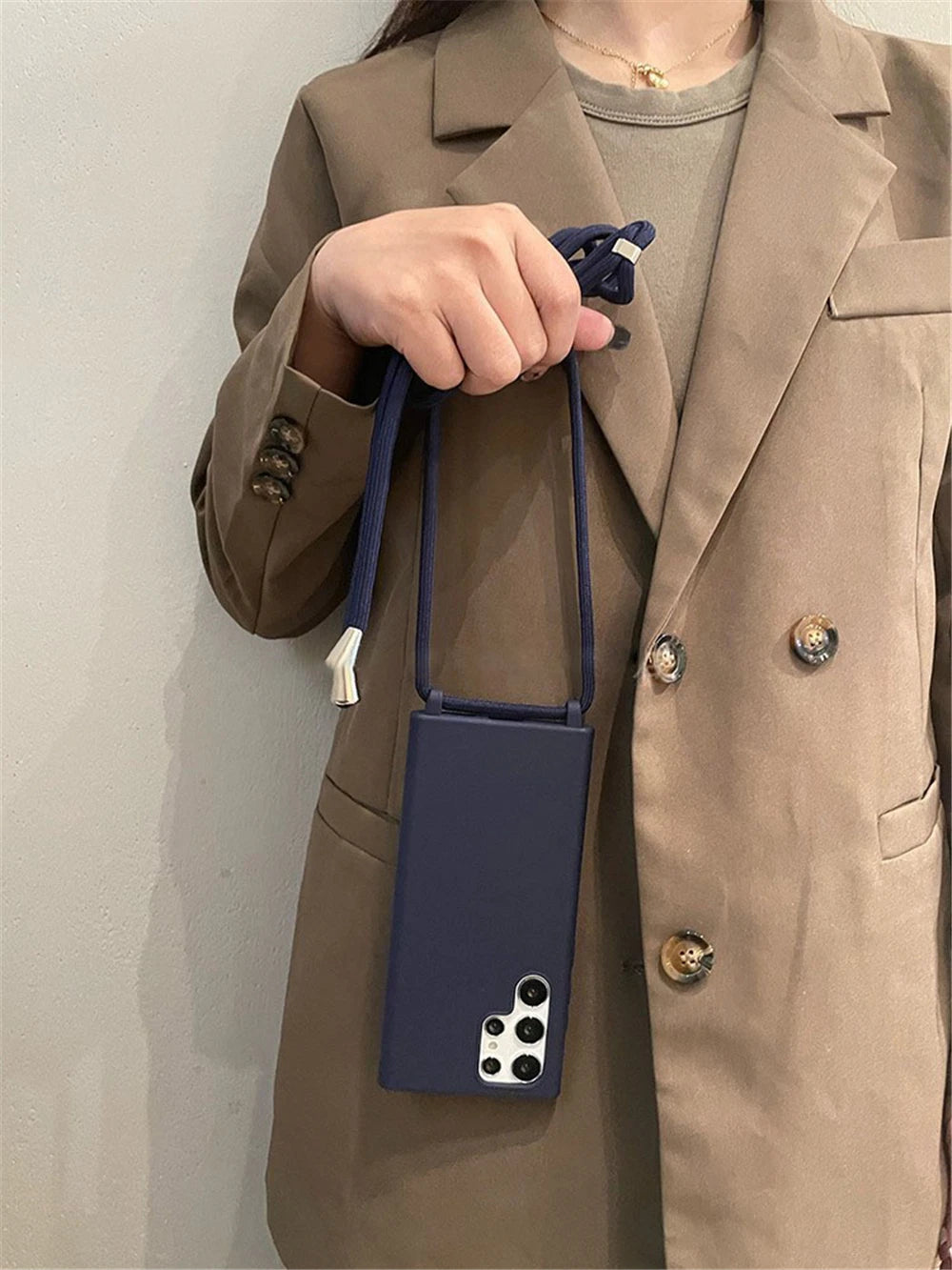 Dark blue mobile phone case with a shoulder strap.