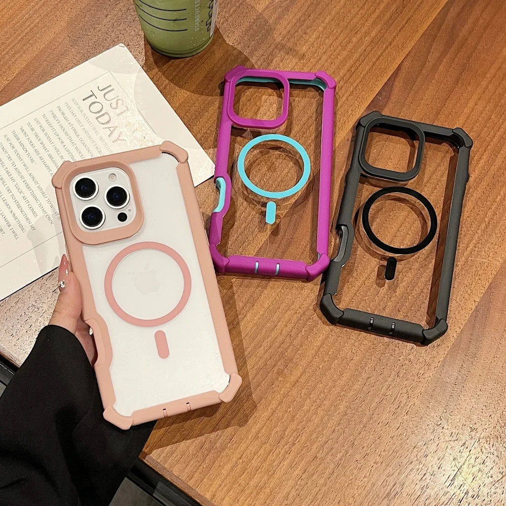 Three clear phone cases with colorful, reinforced borders and magnetic charging rings.