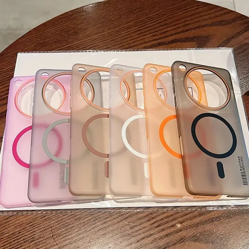 A row of five translucent phone cases in various colors, each with a large circular cutout for a camera and a smaller magnetic charging ring.
