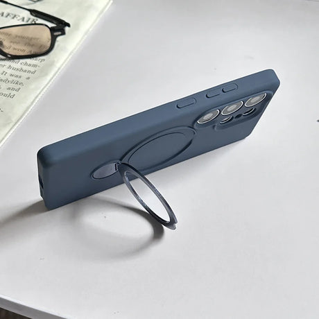 A blue silicone phone case with a built-in magnetic ring stand.
