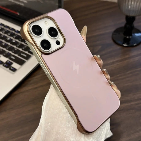 Pink smartphone with a gold-trimmed camera module and side bumper case.