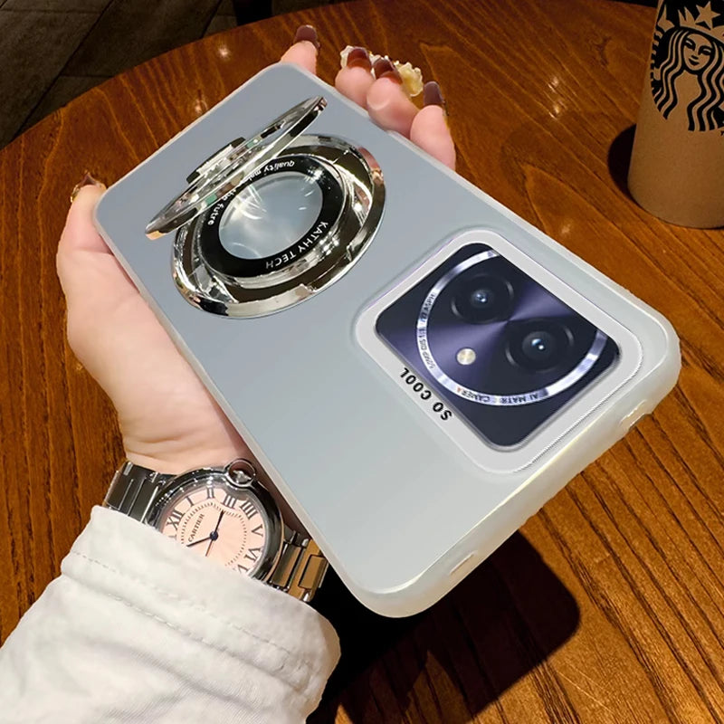 Silver smartphone case with an integrated ring stand and a camera lens protector.