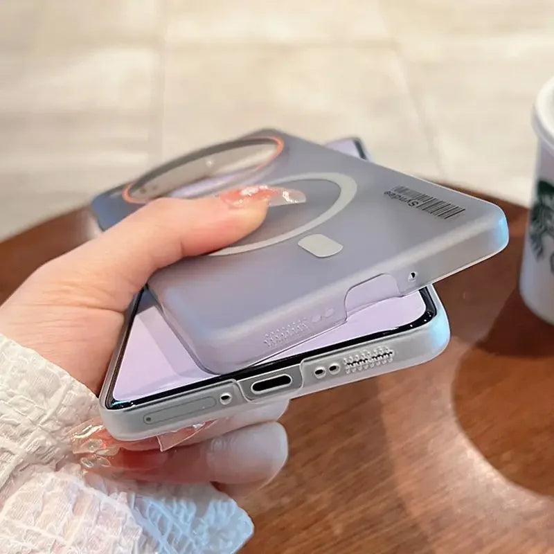 A translucent purple phone case with a magnetic ring, shown being placed onto a smartphone.