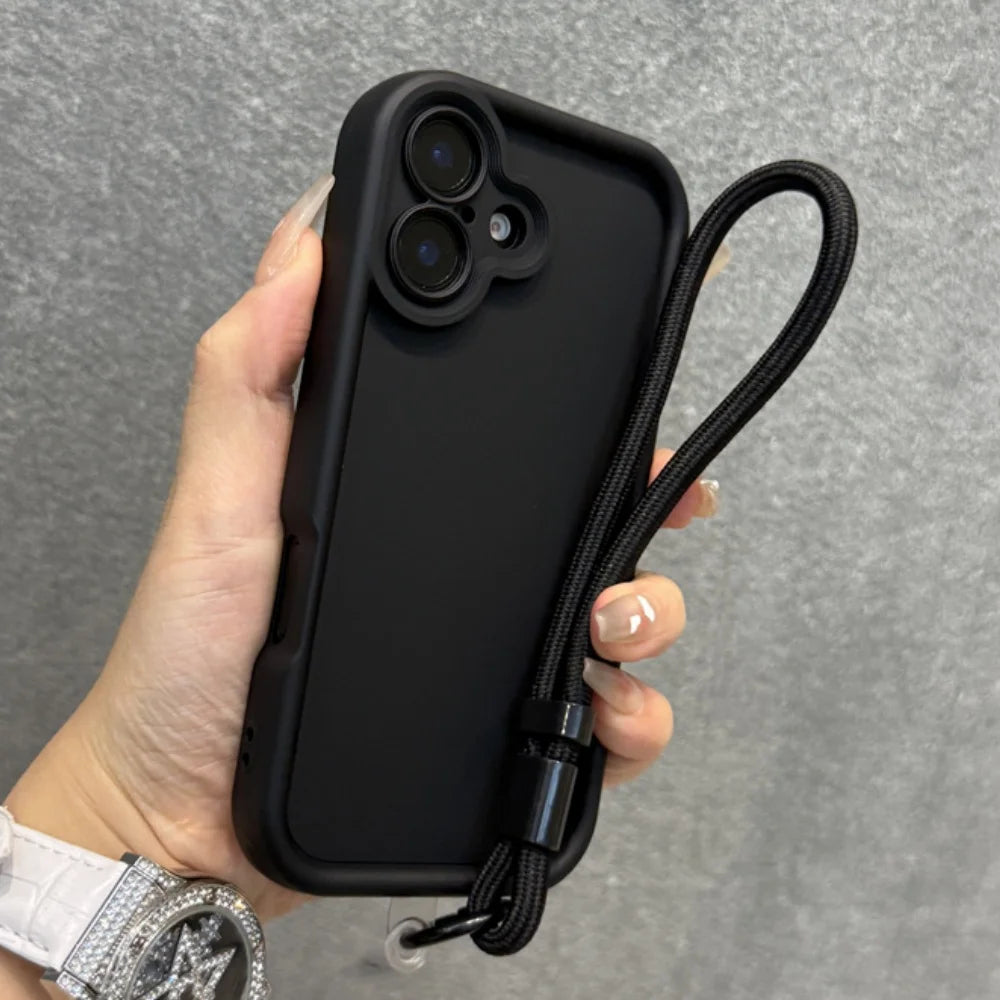Black smartphone with a camera lens protector and wrist strap.