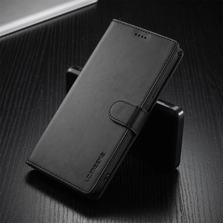 Black leather wallet-style phone case with a magnetic clasp.