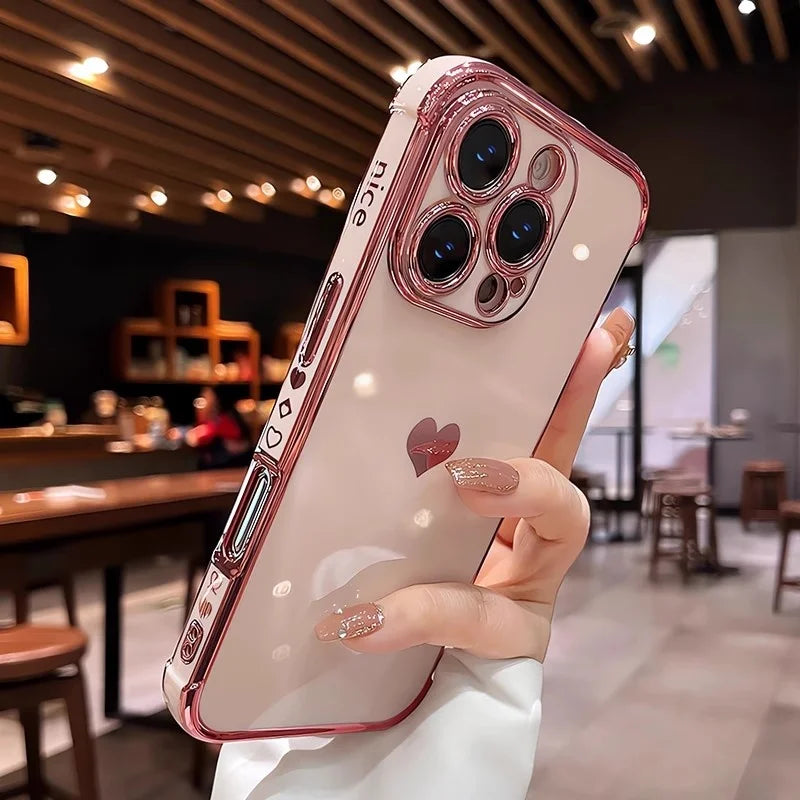 Pink clear phone case with a heart design and camera lens protectors.