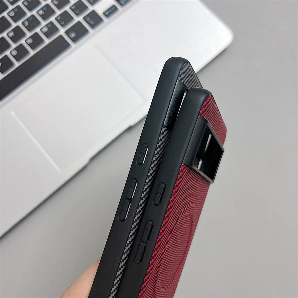 Two smartphones in protective cases, one with a carbon fiber pattern and the other with a red woven texture and a camera bar.