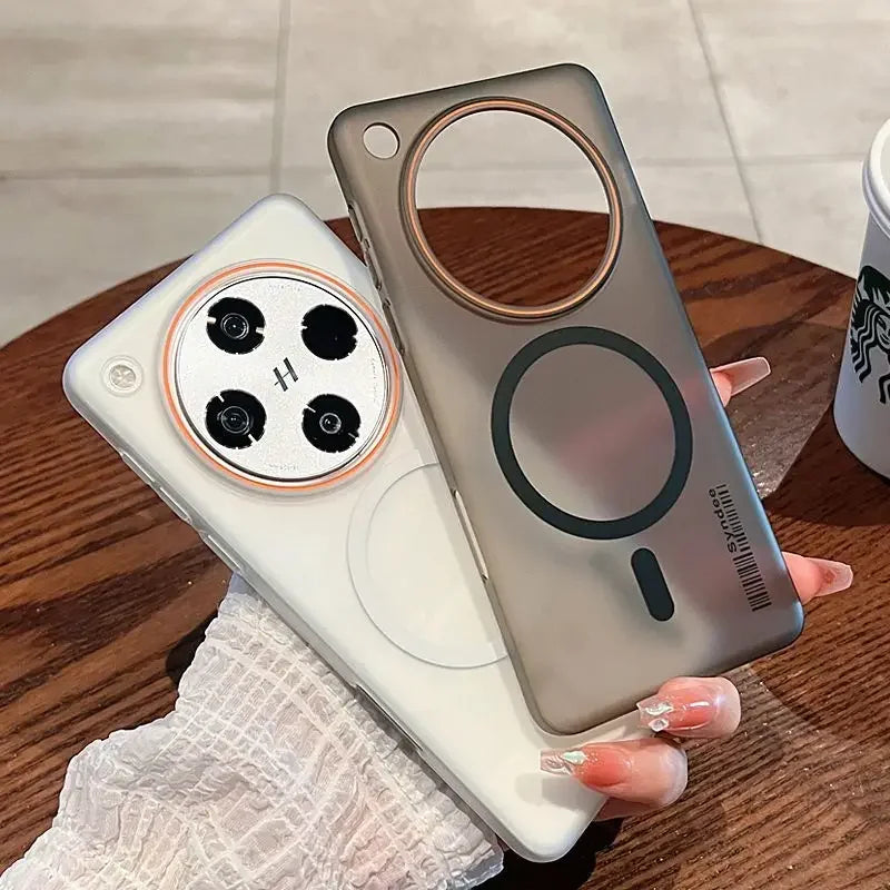 Two translucent phone cases, one white and one smoky gray, with a circular camera cutout and a magnetic charging ring.
