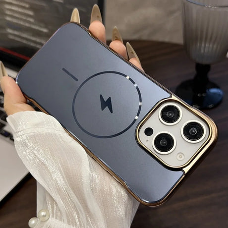 A clear smartphone case with a gold metallic frame, prominent camera cutouts, and a visible MagSafe charging ring and lightning bolt icon.