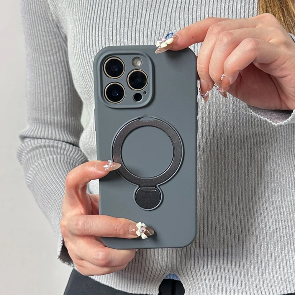 A gray iPhone case with a built-in magnetic ring holder and kickstand.