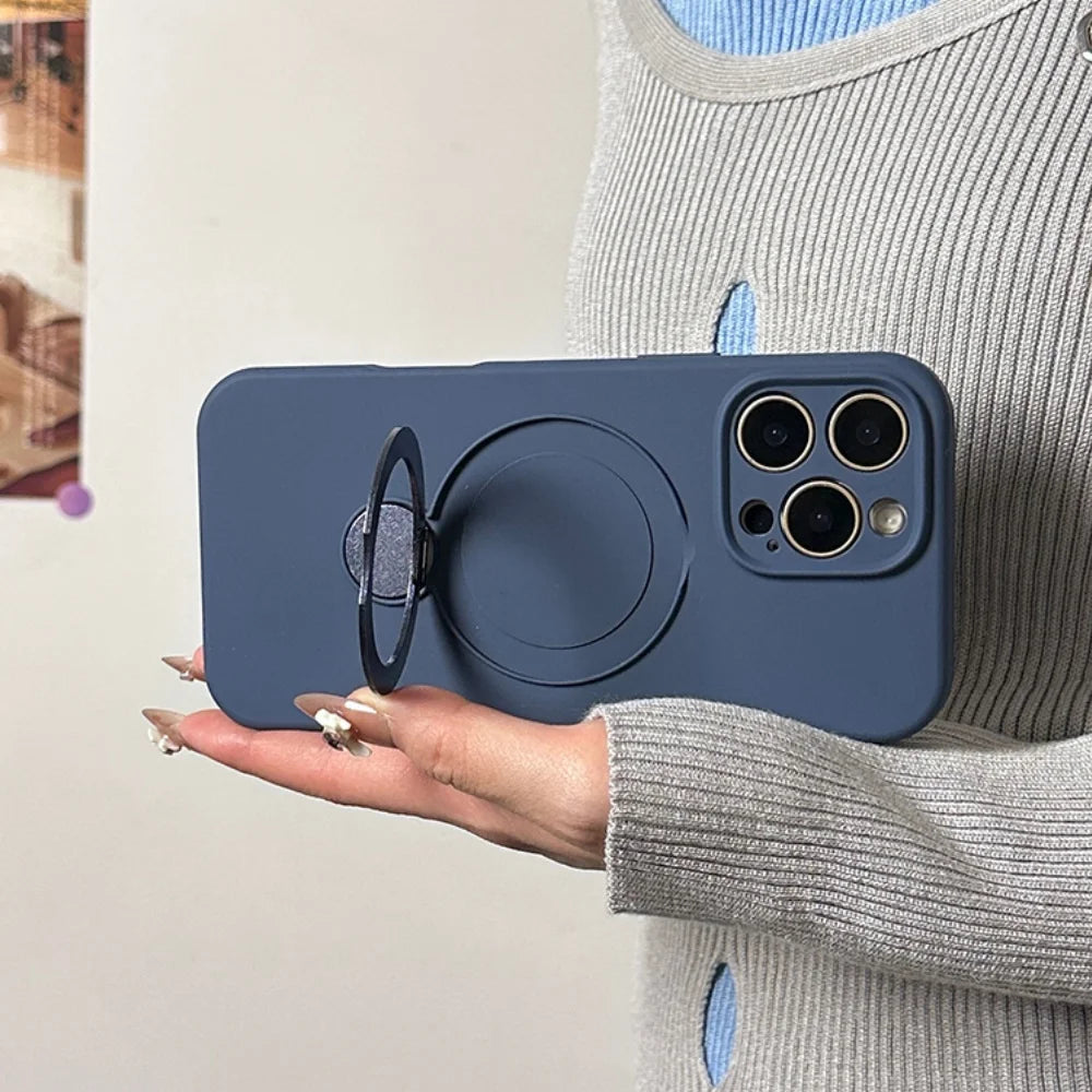 A dark blue phone case with a built-in magnetic ring holder and a camera cutout for three lenses.