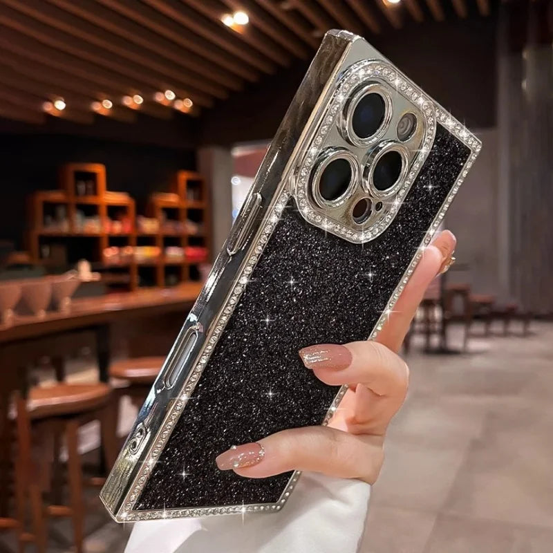A black glittery phone case with a diamond-studded frame and camera cutouts.