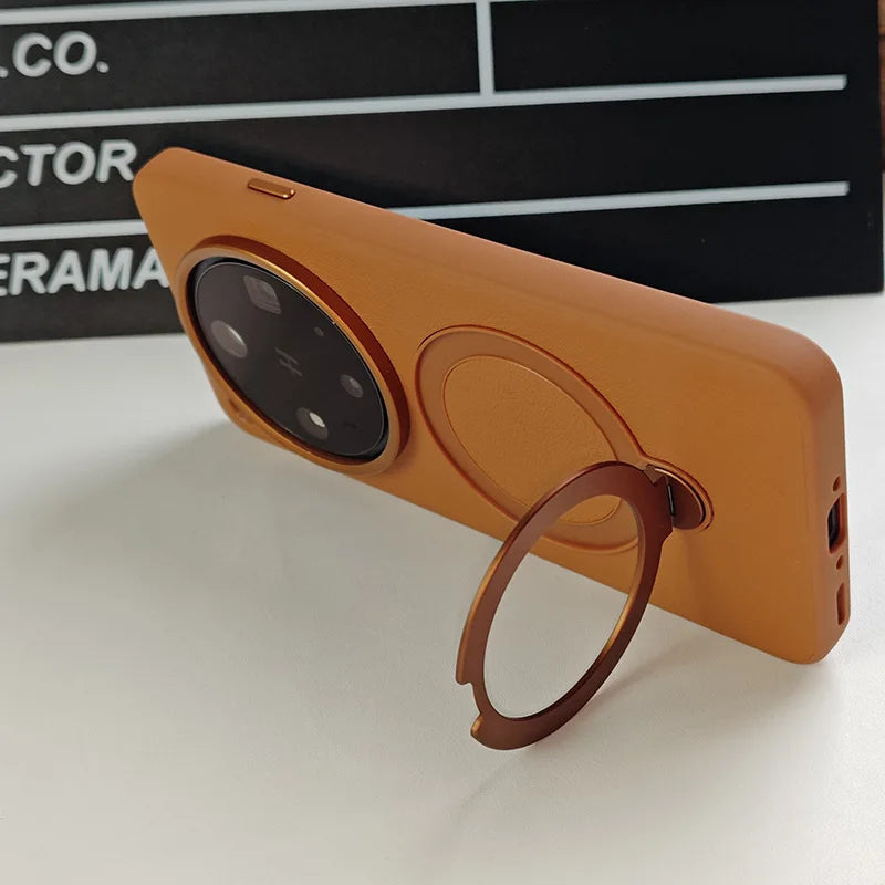 Orange phone case with a built-in kickstand ring and camera protection.
