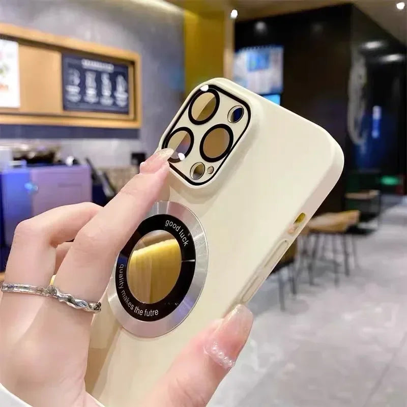 Cream-colored smartphone case with a circular, reflective kickstand and camera lens protectors.