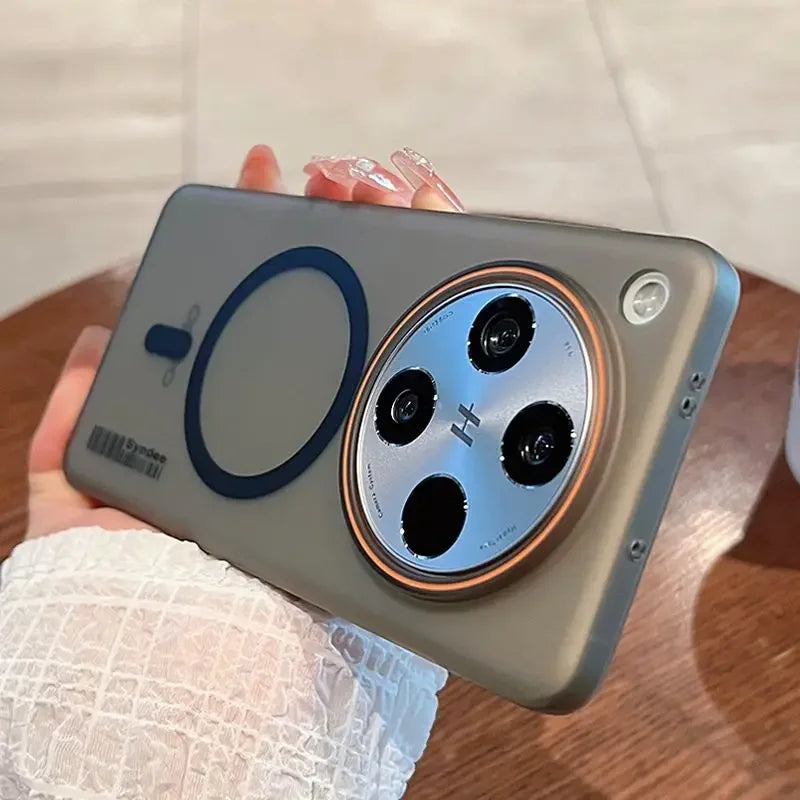 A sleek, grey smartphone in a protective case with a prominent circular camera module and a magnetic charging ring.