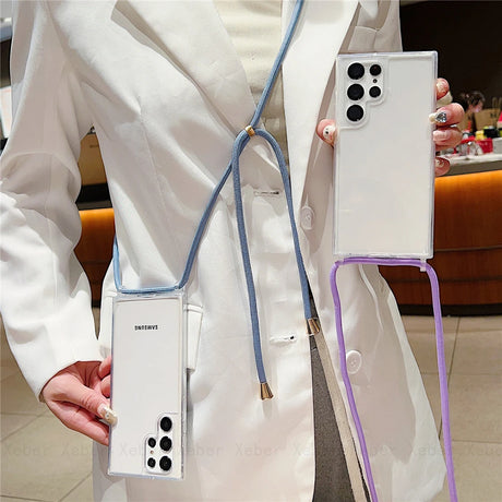 A clear smartphone case with a blue lanyard and a purple strap.