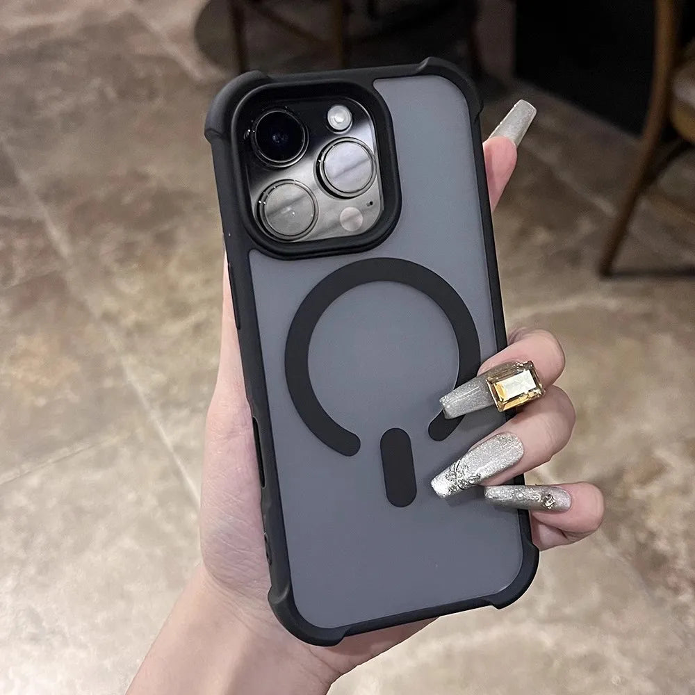 A hand holding a gray iPhone case with a black MagSafe ring and camera protection.