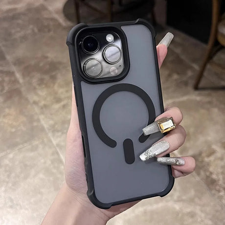 A hand holding a gray iPhone case with a black MagSafe ring and camera protection.