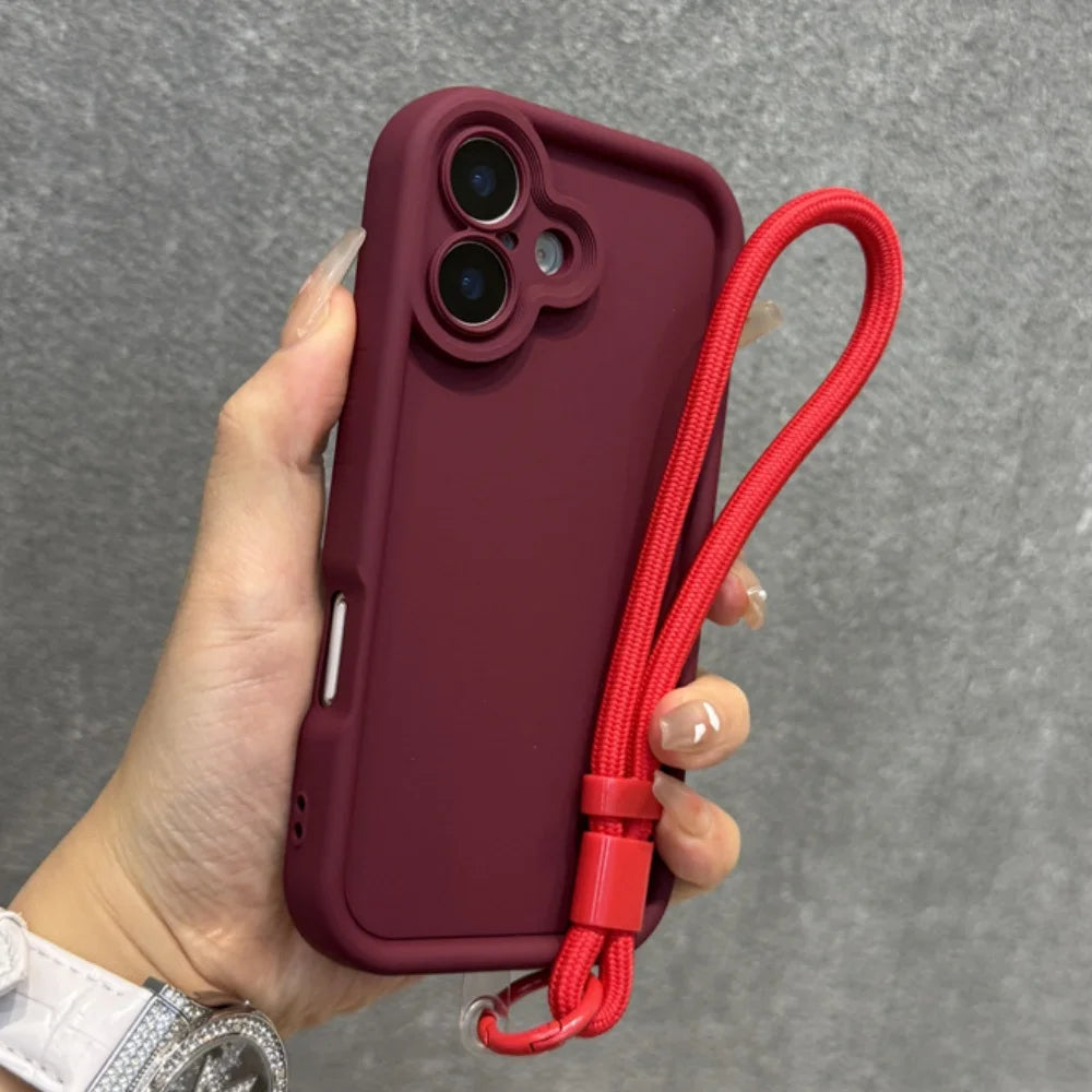 A maroon phone case with a red wrist lanyard.
