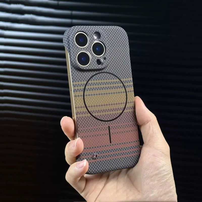 Hand holding a multi-colored, patterned iPhone case with a MagSafe ring.