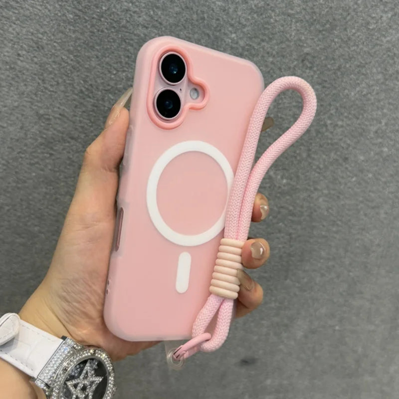Pink iPhone case with a white MagSafe ring, a cutout for dual cameras, and an attached pink braided wrist strap.