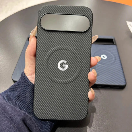 A black carbon fiber phone case with a camera cutout and a white Google ’G’ logo.