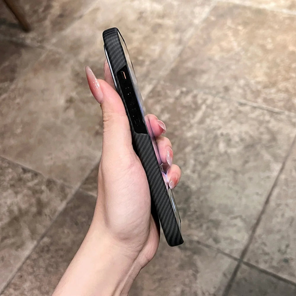 Hand holding a black carbon fiber phone case.