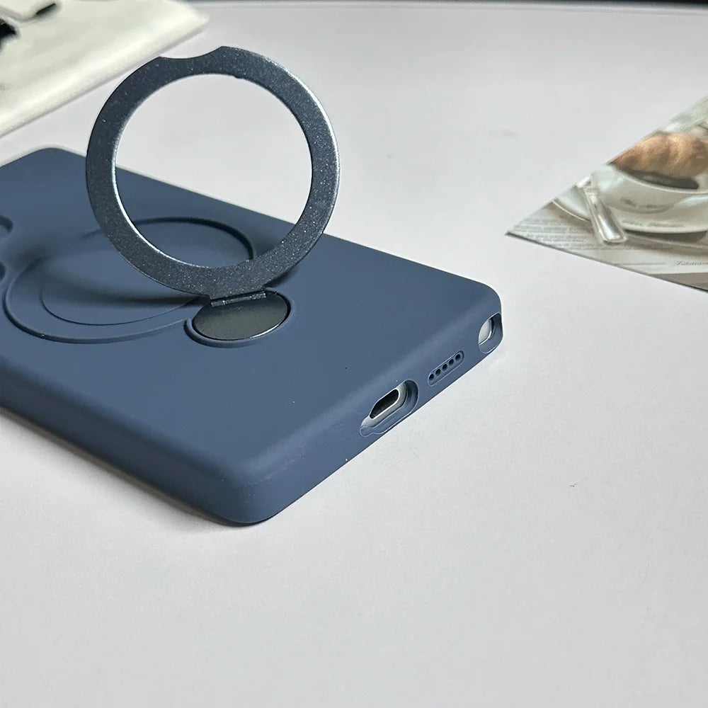 A dark blue phone case with a silver, circular, magnetic ring holder.