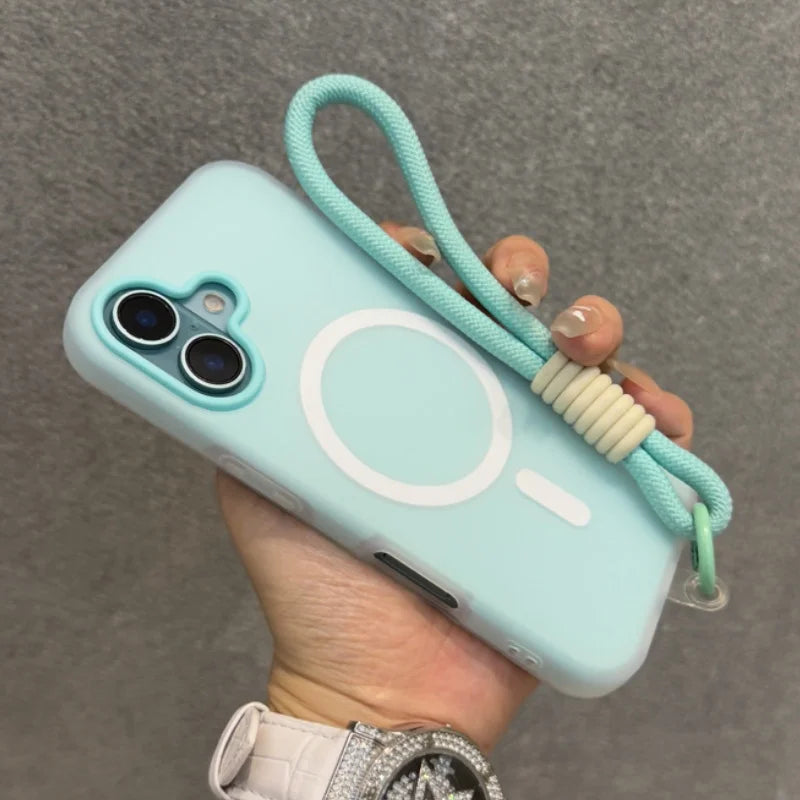 Light blue phone case with a camera cutout, a white magnetic charging ring, and an attached mint green wrist strap.