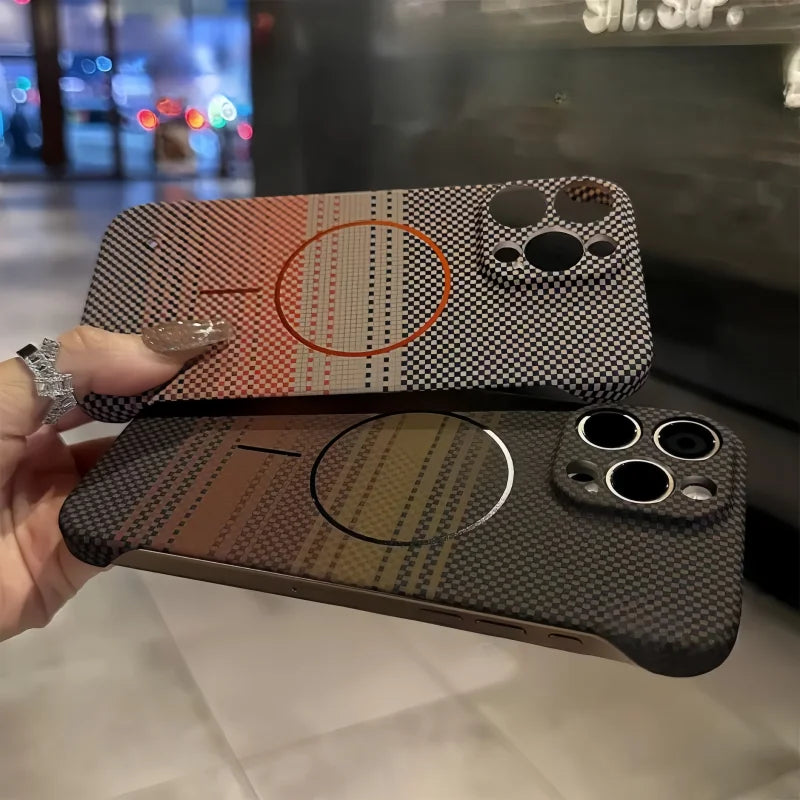Two patterned smartphone cases, one with a reddish-orange stripe and the other with a brown-green stripe, both featuring a checkered design and a circular magnetic charging area.
