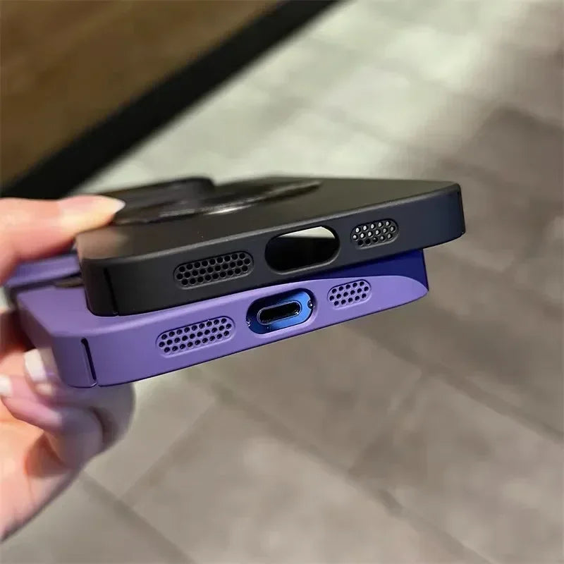 Two smartphone cases, one black and one purple, showing their bottom edges with speaker grilles and charging ports.