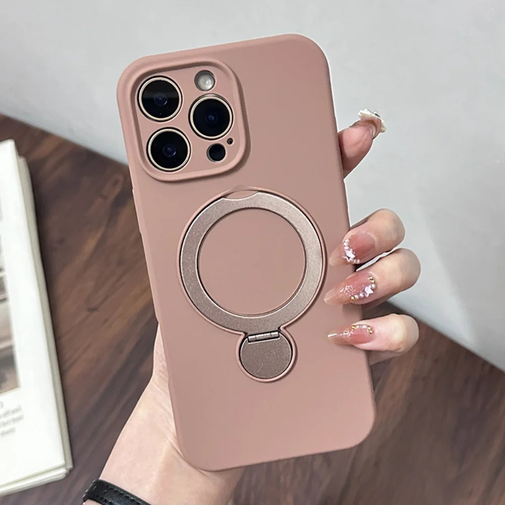 A pink iPhone case with a built-in circular kickstand and camera protection.