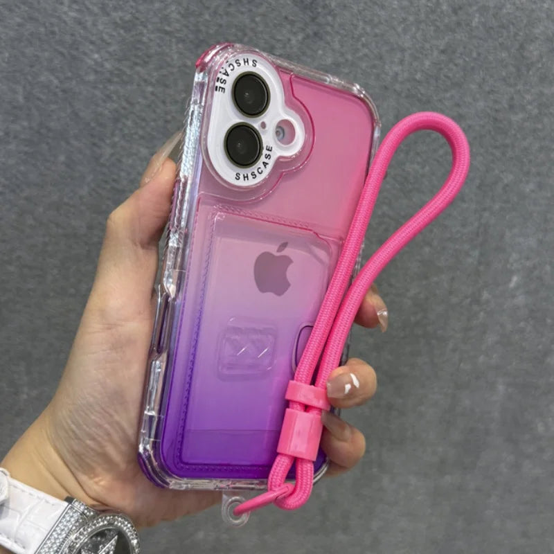 A clear phone case with a pink-to-purple gradient back and an attached bright pink wrist strap.