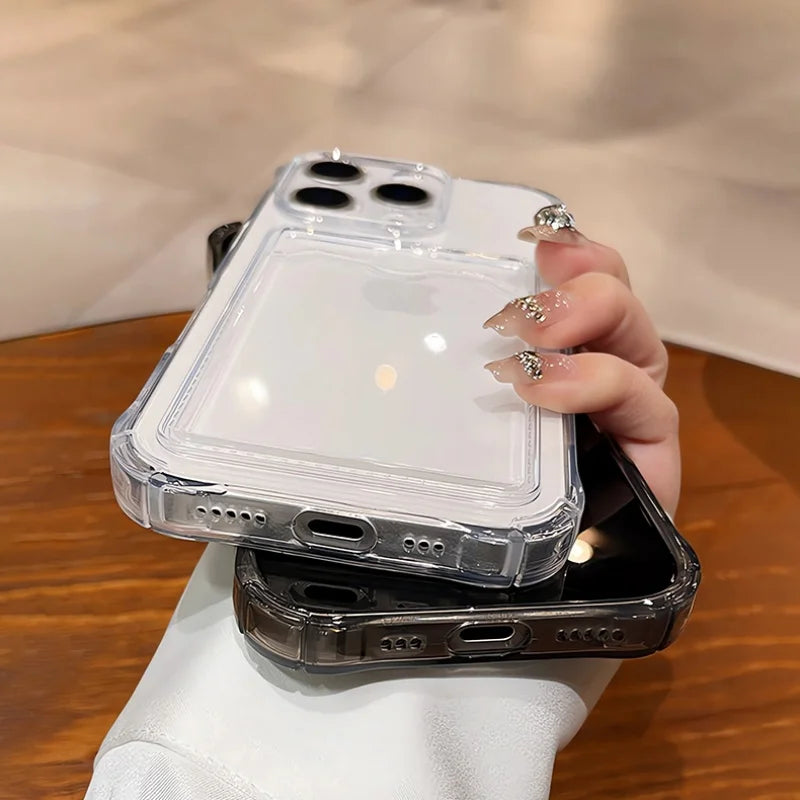 Two clear smartphone cases, one with a card slot, held by a hand with embellished nails.