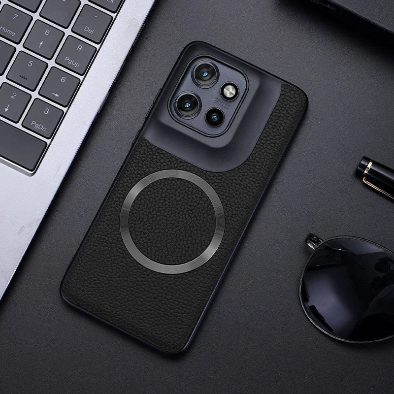 Black smartphone in a textured case with a prominent camera module and a magnetic ring.