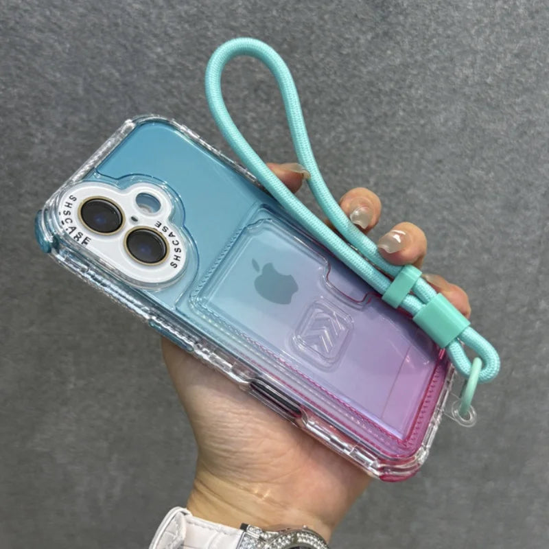 Gradient blue and pink clear iPhone case with a light blue wrist strap.