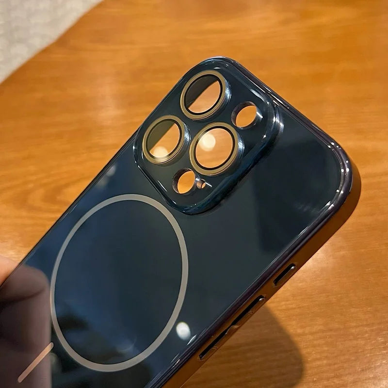 Dark blue smartphone with a clear case showing a circular magnetic charging area and a prominent triple camera system.