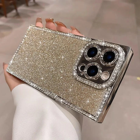 Glittering gold smartphone case with diamond-studded edges and camera lens frame.
