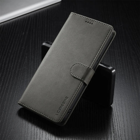 Dark grey faux leather wallet phone case with a magnetic clasp.
